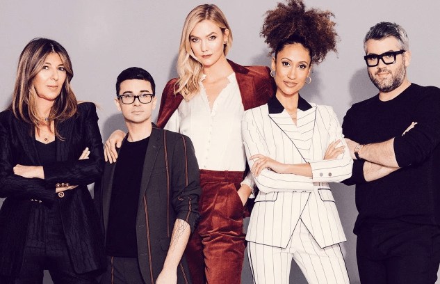 the judges and presenters of Project Runway wearing suits and posing